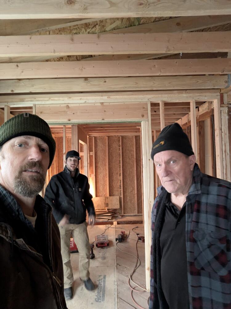 Framing day — multi-generation crew at work