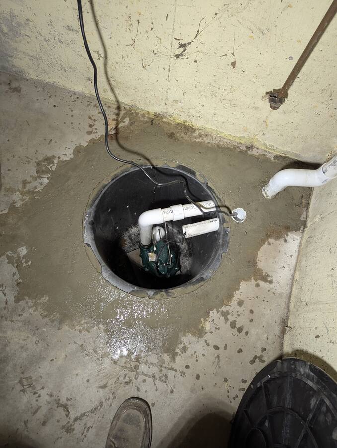 Sump pump and check-valve assembly inside the basin