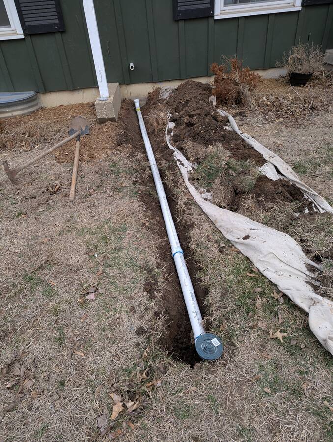 New exterior discharge line installed away from the foundation