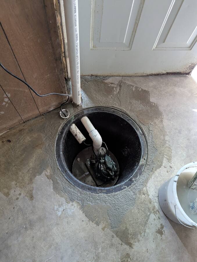 Sump pump basin installation in progress