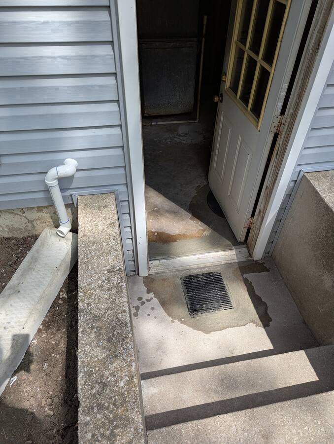Exterior stairwell / area drain at basement entry